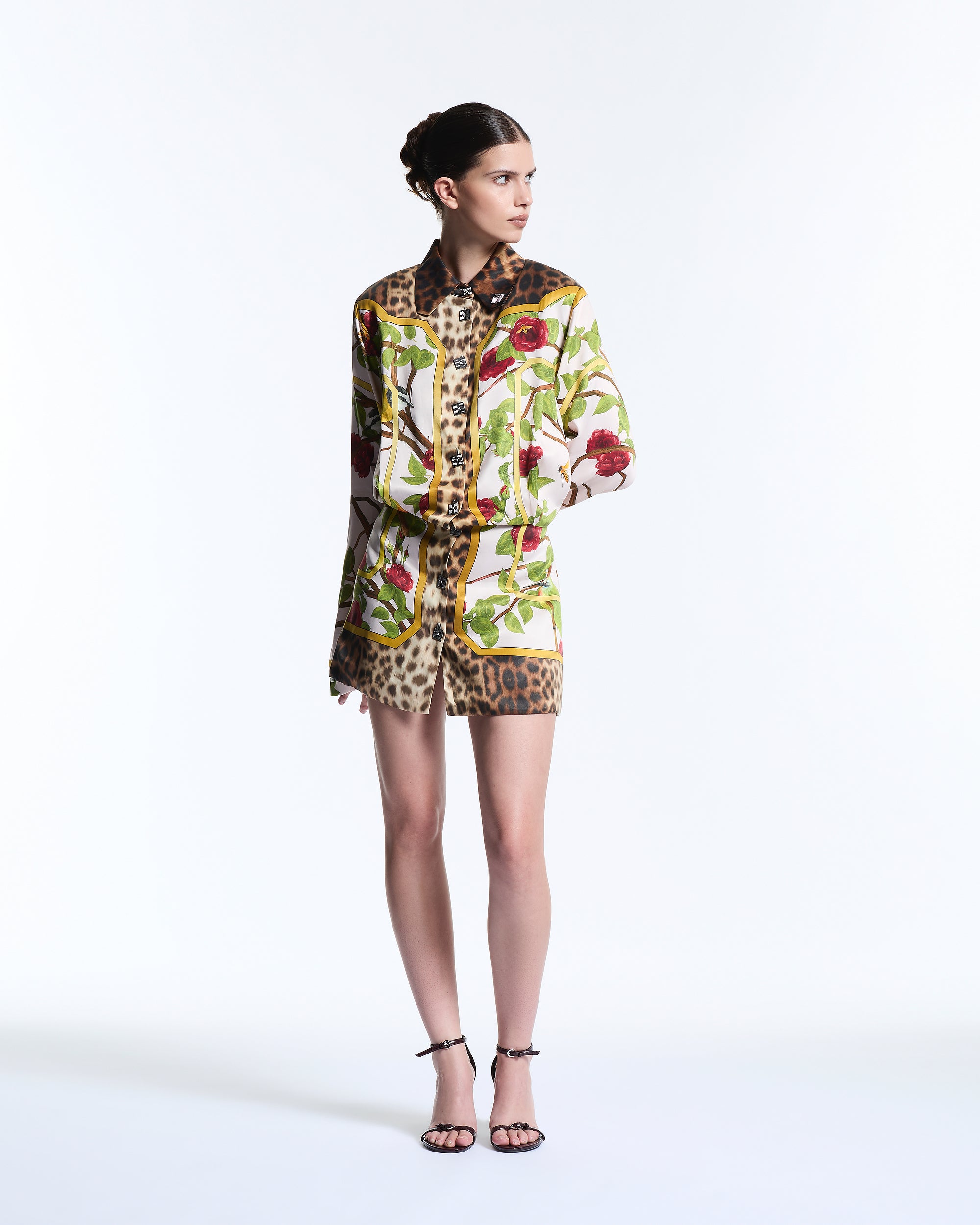 Model wearing a floral and leopard print outfit on a white background