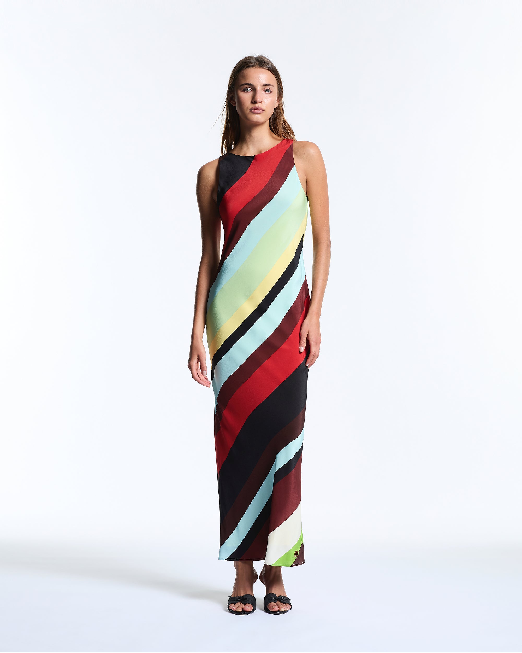 Woman wearing a colorful striped dress on a white background