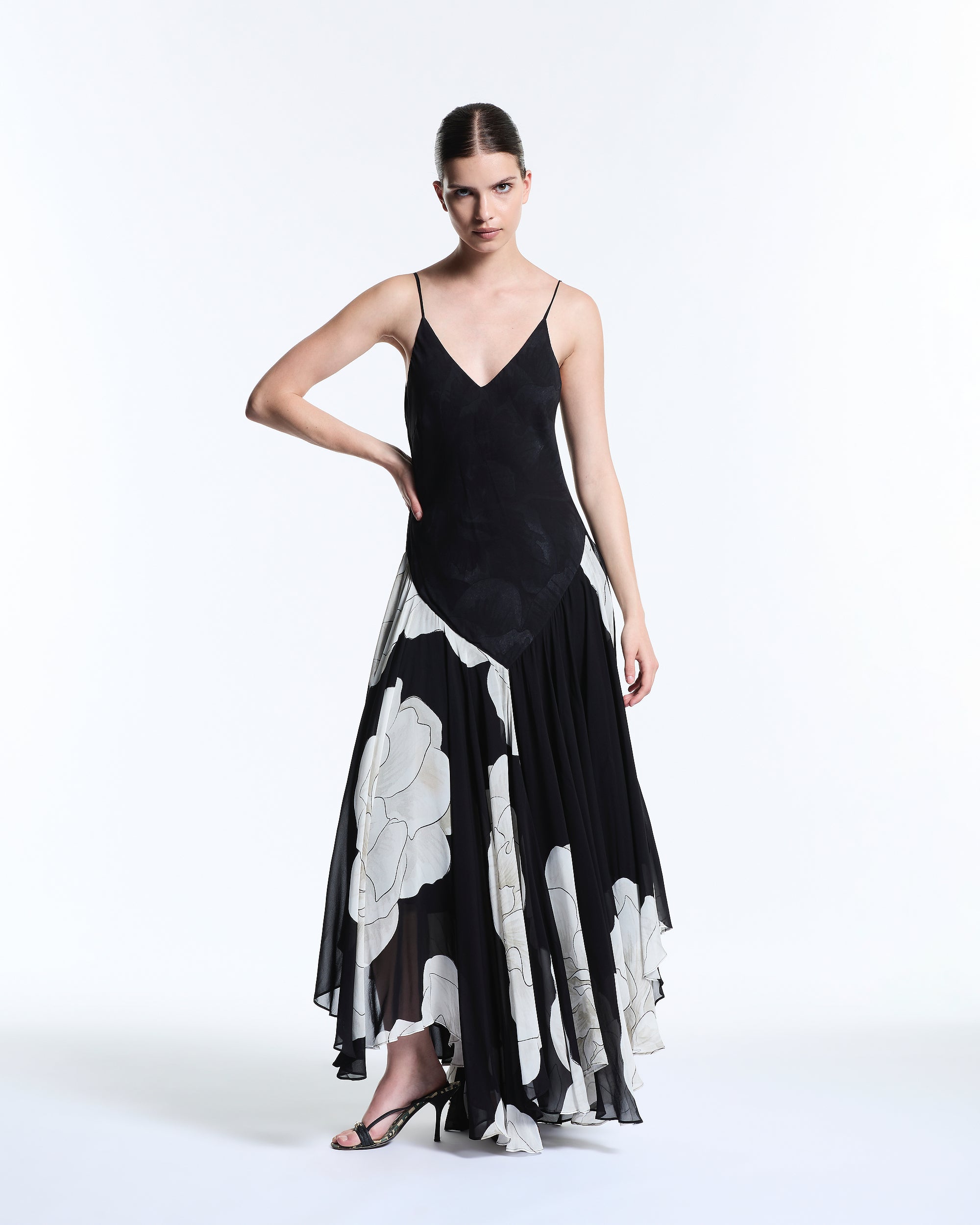 Woman wearing a black and white floral dress on a white background